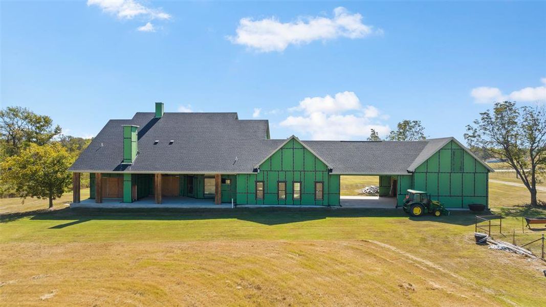 Rear view of property featuring a lawn