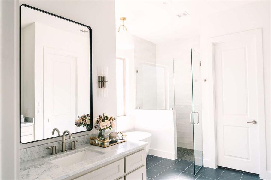 Bathroom with tile patterned flooring, vanity, and walk in shower