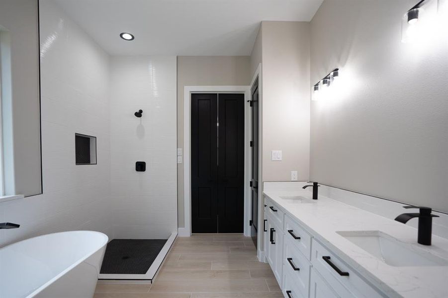 This bathroom features double sinks, a  soaking tub PLUS a glass shower with stunning tile selections.