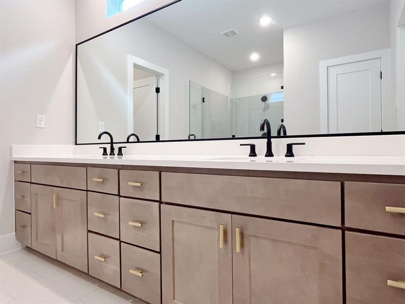 Ensuite Oasis: Sleek dual-sink vanity, modern fixtures, and ample storage.