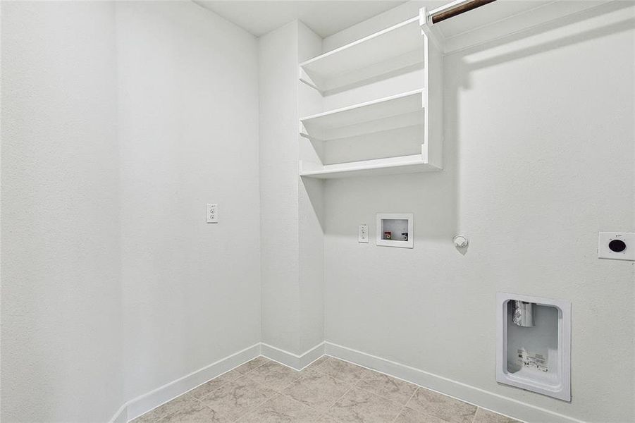 Washroom with washer hookup, light tile patterned floors, hookup for an electric dryer, and hookup for a gas dryer