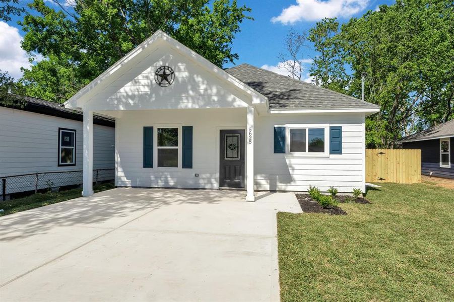 Covered Entryway - The front porch provides a sheltered entrance, adding a touch of traditional elegance.