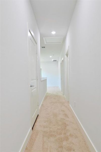 Hallway with light colored carpet