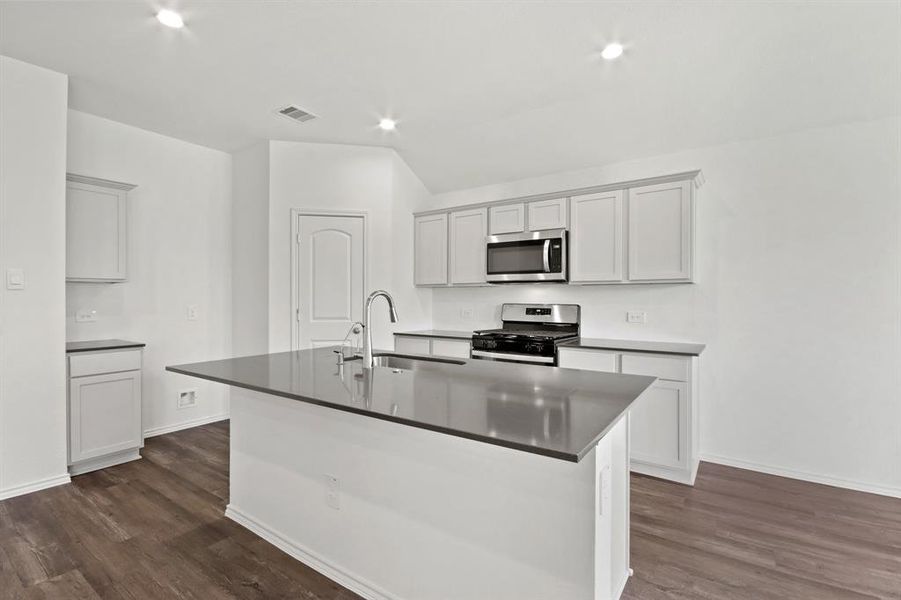 Representative image provided by builder. Subject home will have gray cabinetry & white countertops.