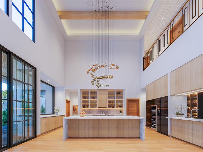 Kitchen featuring light wood-type flooring, light brown cabinetry, a towering ceiling, sink, and a kitchen island