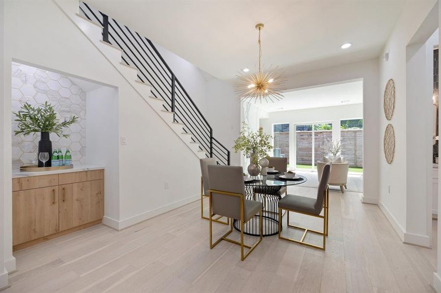 The dry bar with ceiling height marble tile is the perfect accent to this open concept.