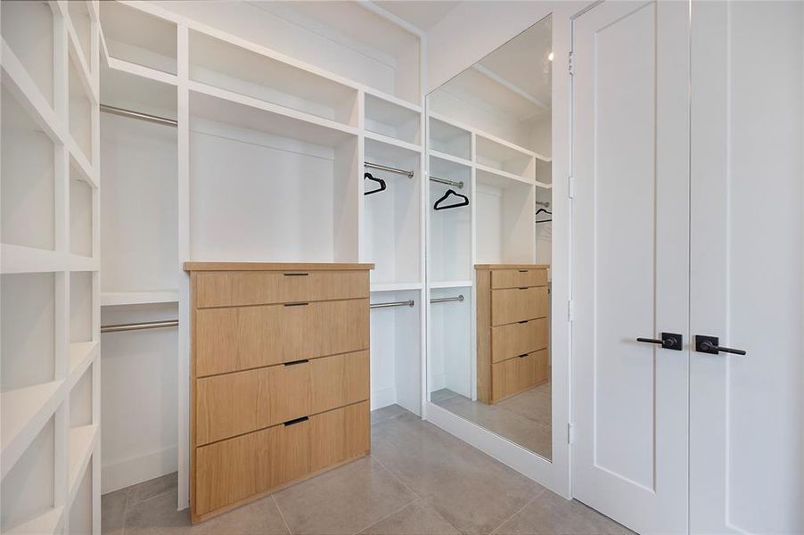 Spacious closet with light tile patterned floors