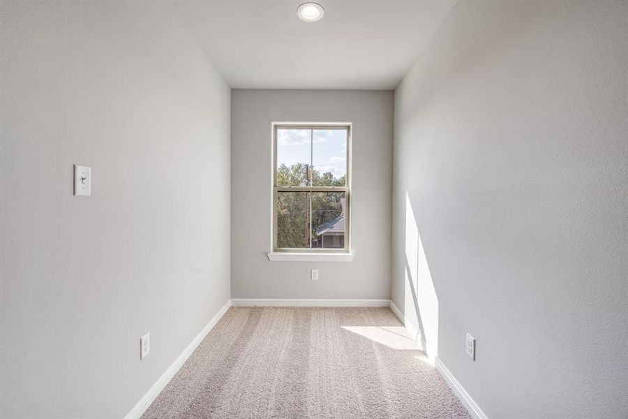 Unfurnished room with light colored carpet