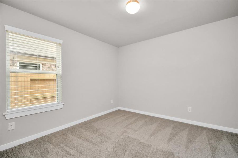 Generously sized secondary bedrooms featuring spacious closets, soft and inviting carpeting underfoot, large windows allowing plenty of natural light, and the added touch of privacy blinds for your personal retreat