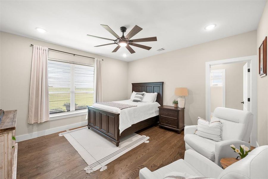 Bedroom with hard wood flooring and ceiling fan