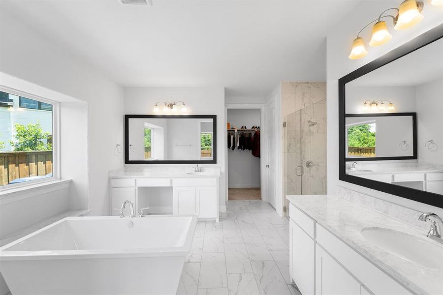 Bathroom featuring a healthy amount of sunlight, large vanity, plus walk in shower, and tile floors