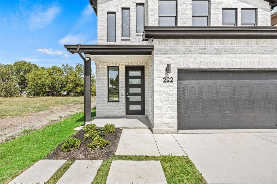 Doorway to property with a garage