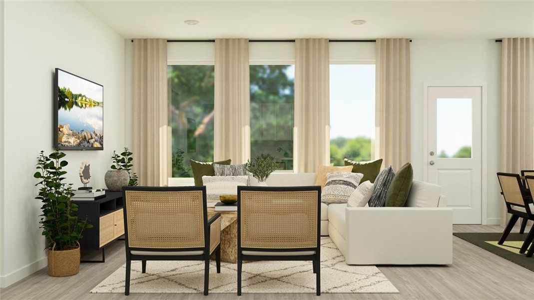 Living area with a wealth of natural light and light hardwood / wood-style floors