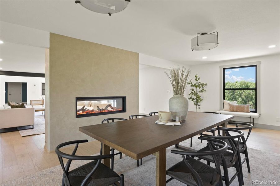 Dinning space with 50 inch see through fireplace into living room