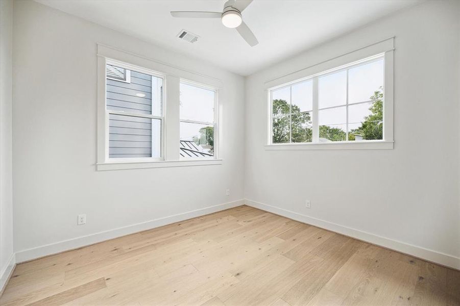 Third bedroom with multiple windows allowing a lot of natural light in the room, a closet, ceiling fan and direct access to a full bathroom. This room also has a nice walk in closet.