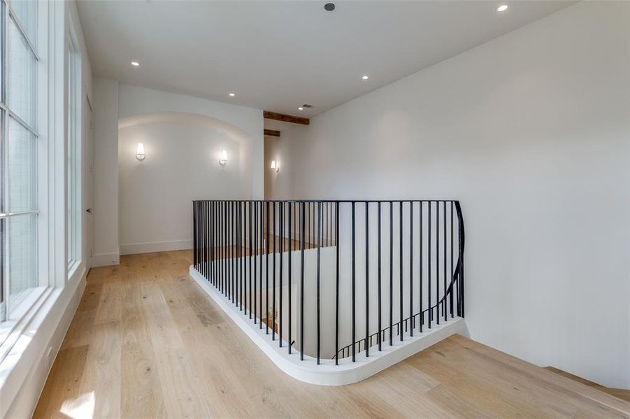 Hallway featuring light hardwood / wood-style flooring and a healthy amount of sunlight