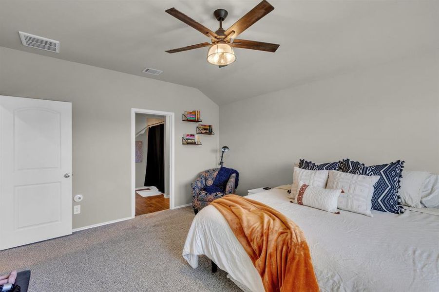 A secondary view of the primary bedroom highlighting the abundance of space as you enter into your large bathroom area.