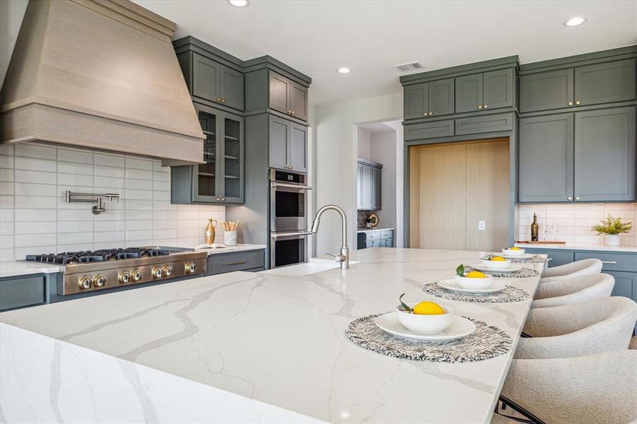 Notice the pot filler faucet, glass cabinet inserts and the cabinets to the ceiling.