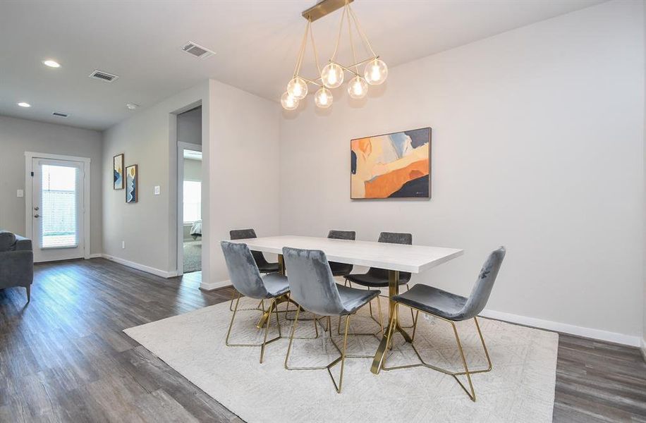 Dining room area with a large dining table and modern decor.