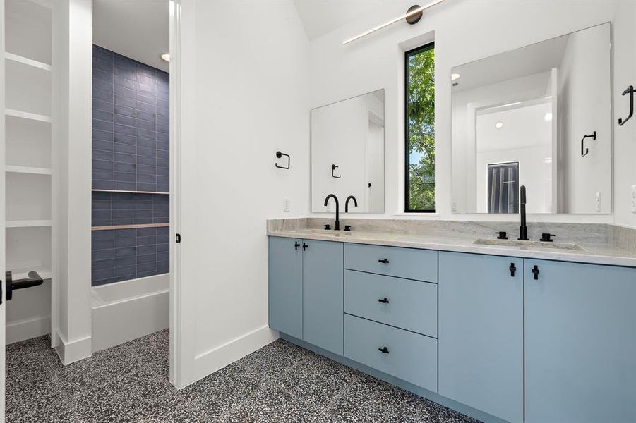 Upstairs guest bathroom with dual sinks