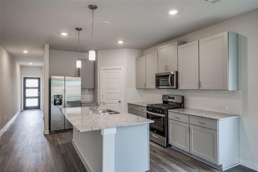 Kitchen features stainless steel appliances.
