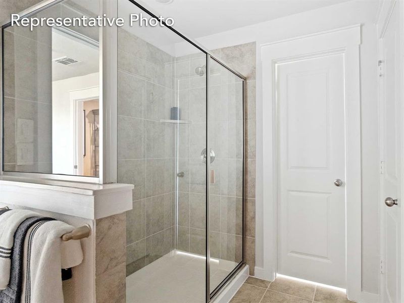 Bathroom with tile patterned floors and walk in shower