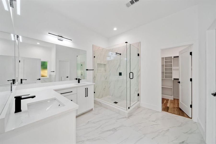 Bathroom with vanity, hardwood / wood-style floors, and a shower with shower door