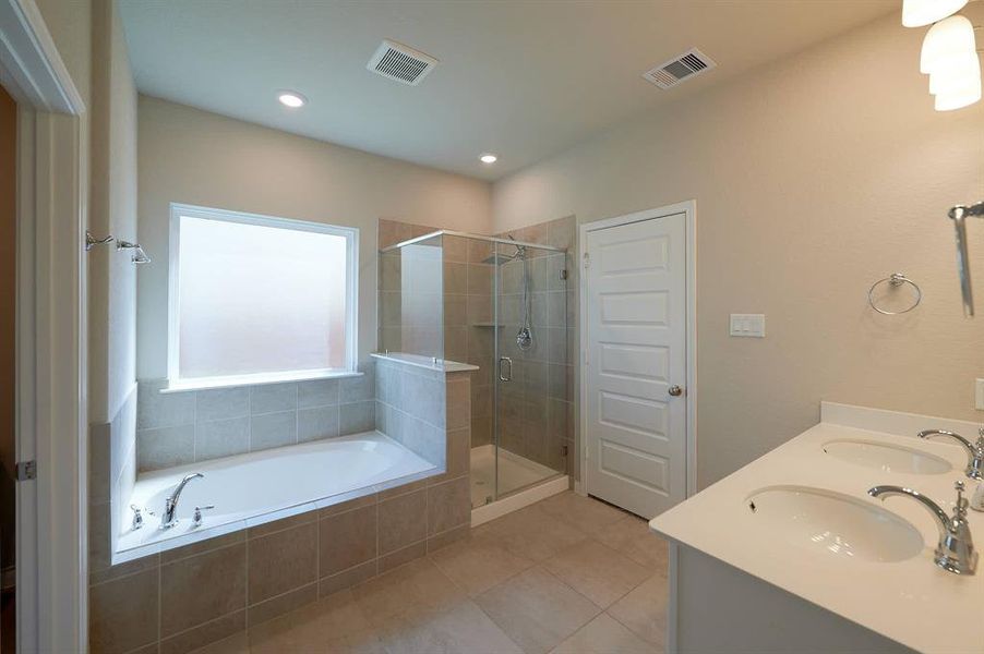 Ensuite bath with separate glass shower and soaking tub.