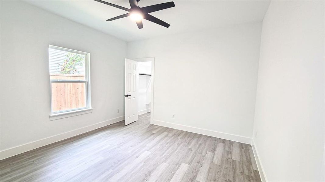 Room with ceiling fan light wood-style high-end vinyl floors