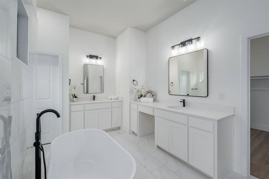 Master Bathroom featuring a tub to relax in and vanity