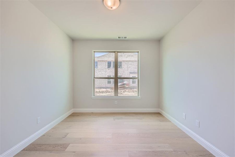 Spare room featuring a healthy amount of sunlight and light hardwood / wood-style floors