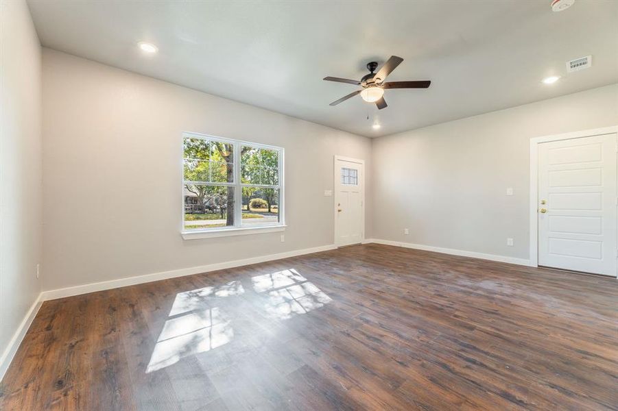 Spare room featuring ceiling fan and dark hardwood / wood-style flooring