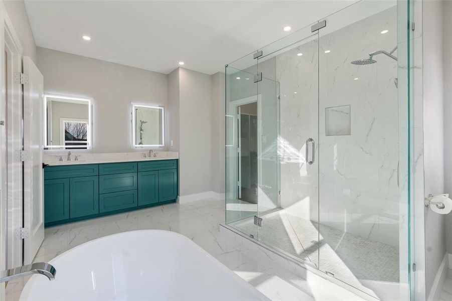 Bathroom with vanity and shower with separate bathtub