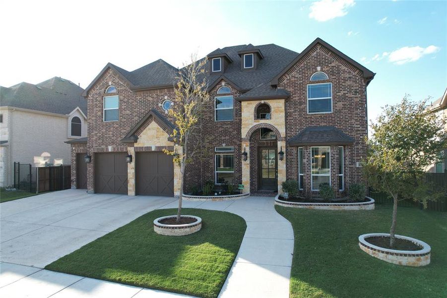 View of front of property with a front yard and a garage