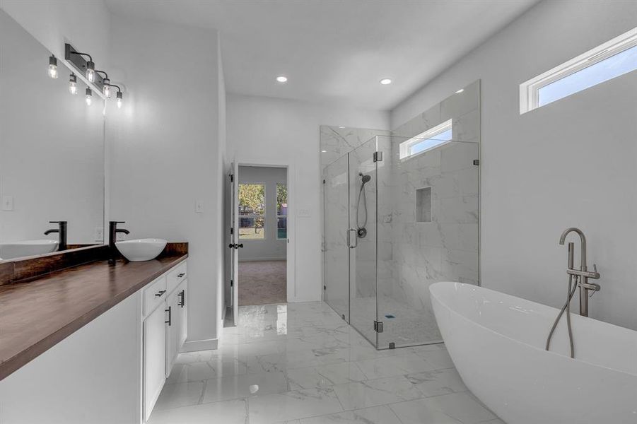 Bathroom with plenty of natural light, vanity, and separate shower and tub