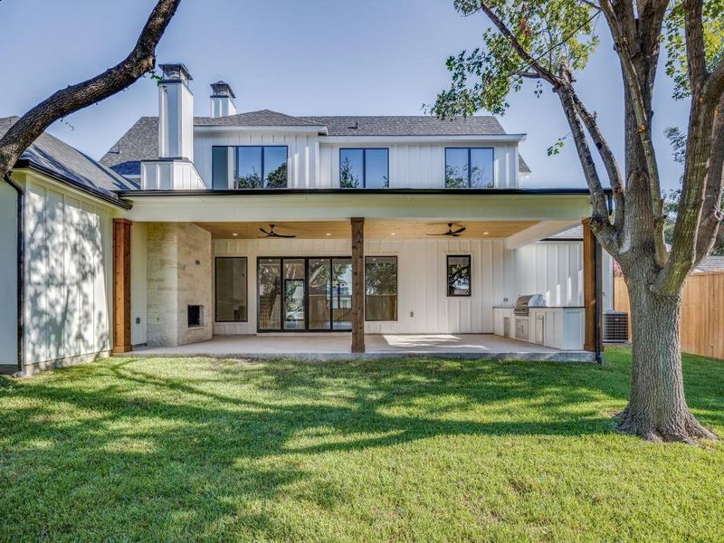 Back of property featuring a yard, ceiling fan, and a patio