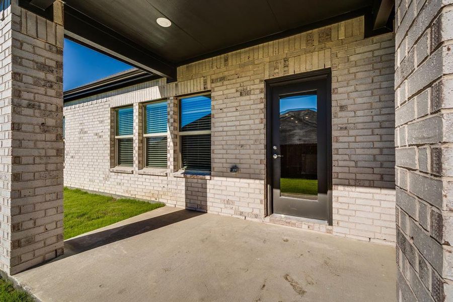 Doorway to property featuring a patio