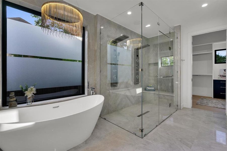 Bathroom featuring shower with separate bathtub and vanity