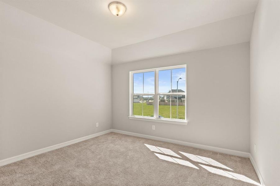 Your secondary bedroom features plush carpet, fresh paint, closet, and a large window that lets in plenty of natural lighting.