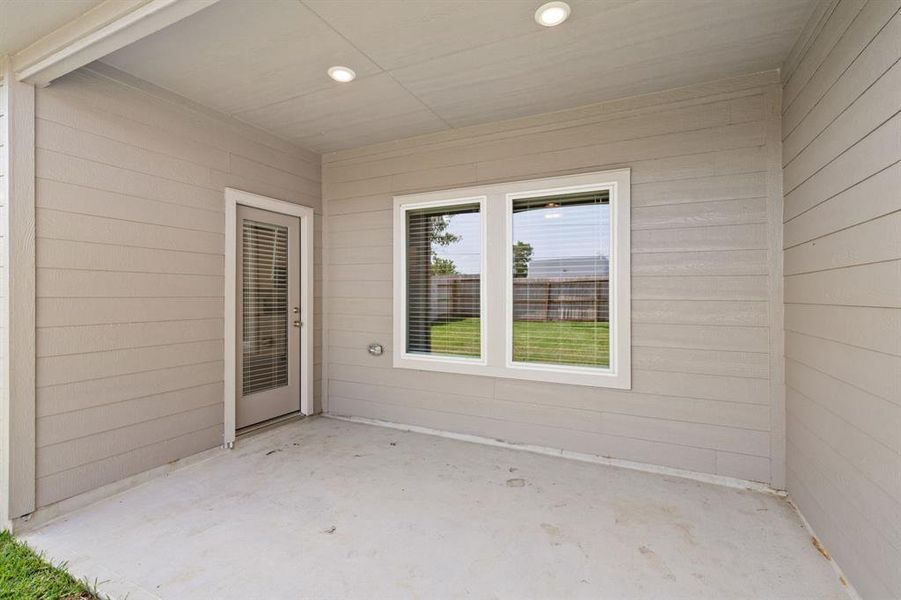 The Charming Covered Patio is a welcoming outdoor space, ideal for al fresco dining, entertaining guests, or simply unwinding in the fresh air.