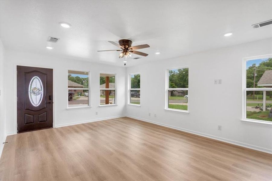 Foyer with ceiling fan and light hardwood / wood-style flooring
