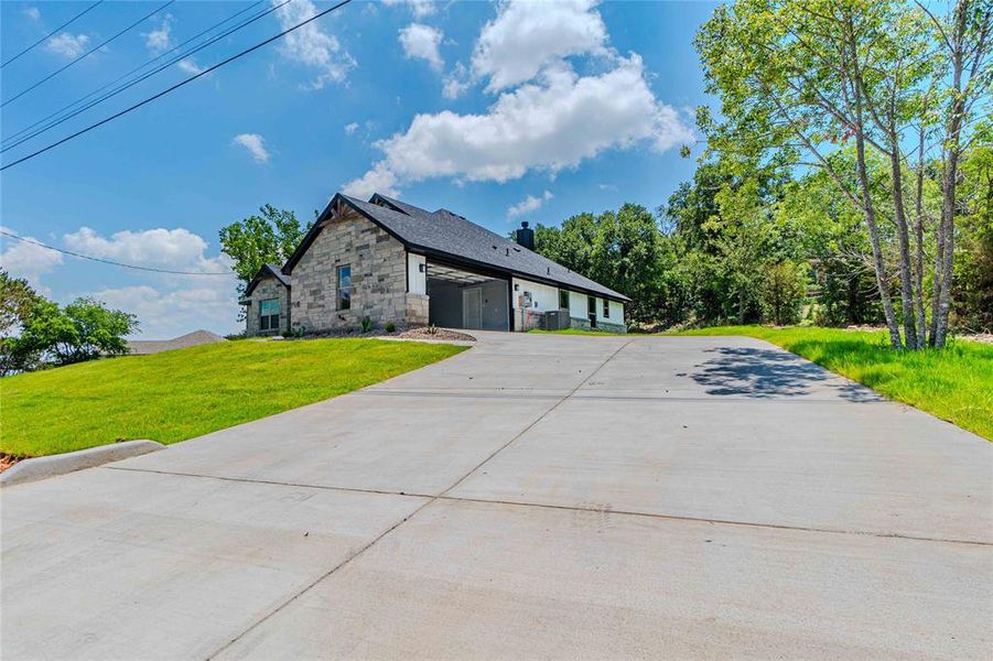 View of front of property with a front yard and a garage