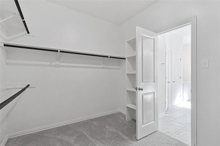 Spacious closet with light tile floors