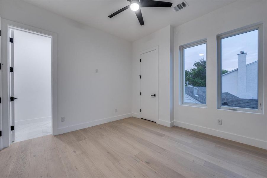 Empty room featuring ceiling fan and light hardwood / wood-style flooring