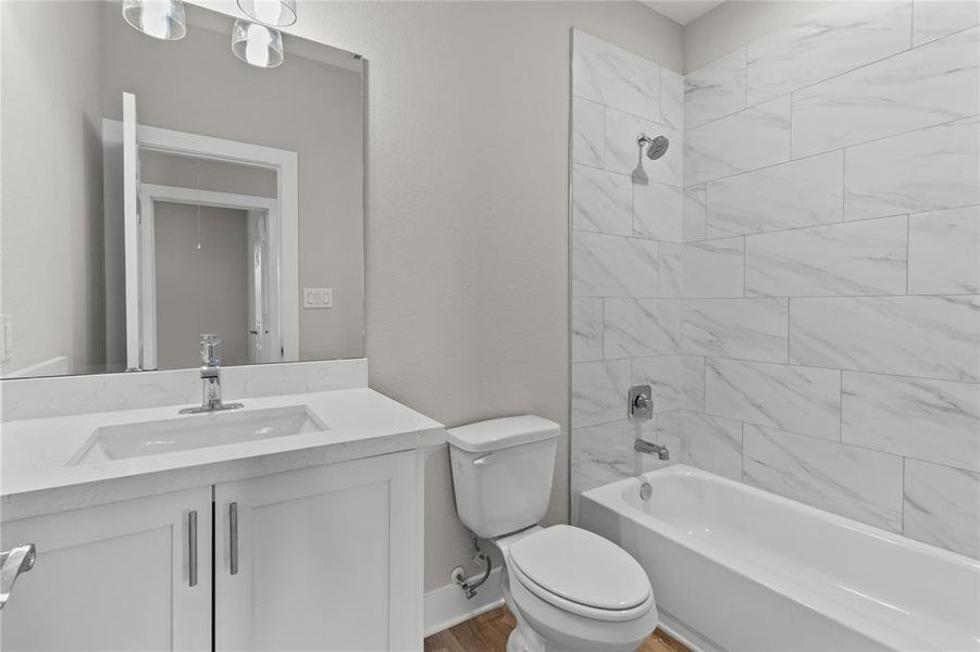 The full bathroom upstairs serves the secondary bedrooms with style and functionality.