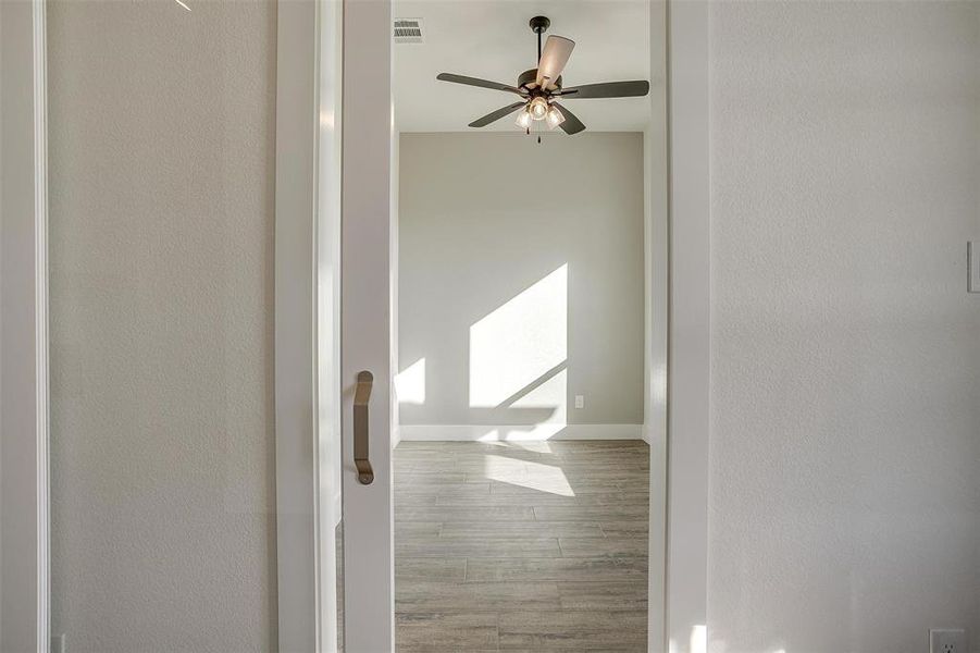 Hall with hardwood / wood-style flooring