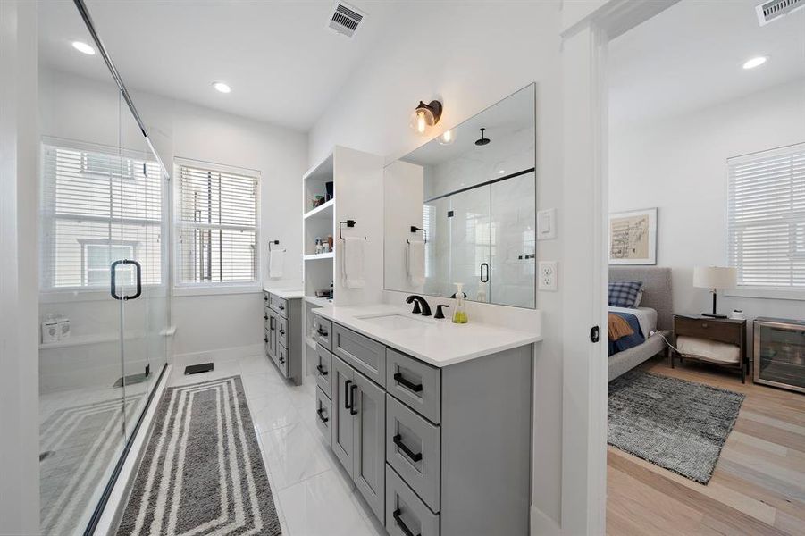 Huge primary Shower featuring double vanities and tons of storage space.