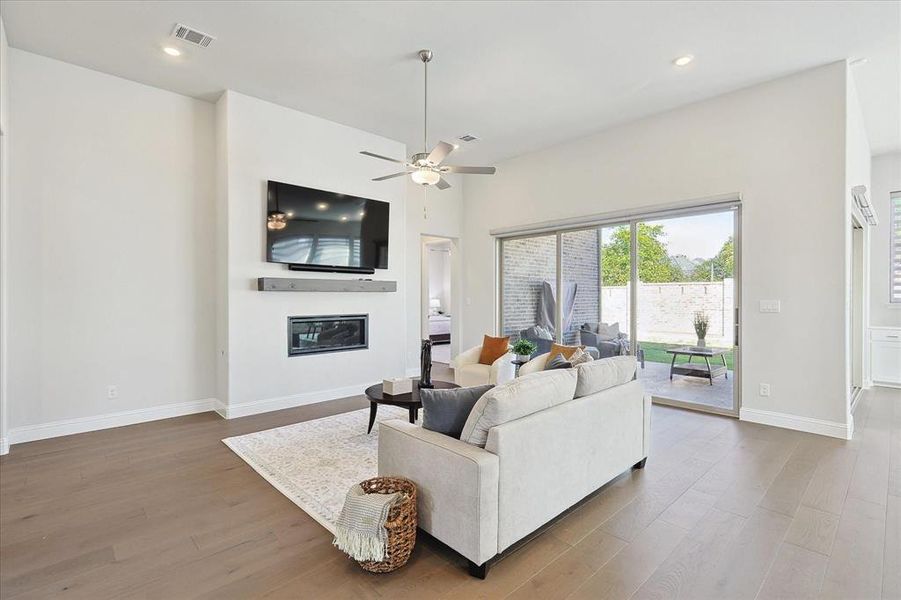 Living room featuring wood-type flooring and ceiling fan