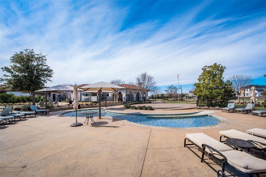 View of pool featuring a hot tub and a patio area