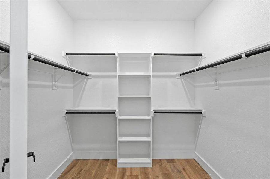 Spacious closet featuring hardwood / wood-style floors